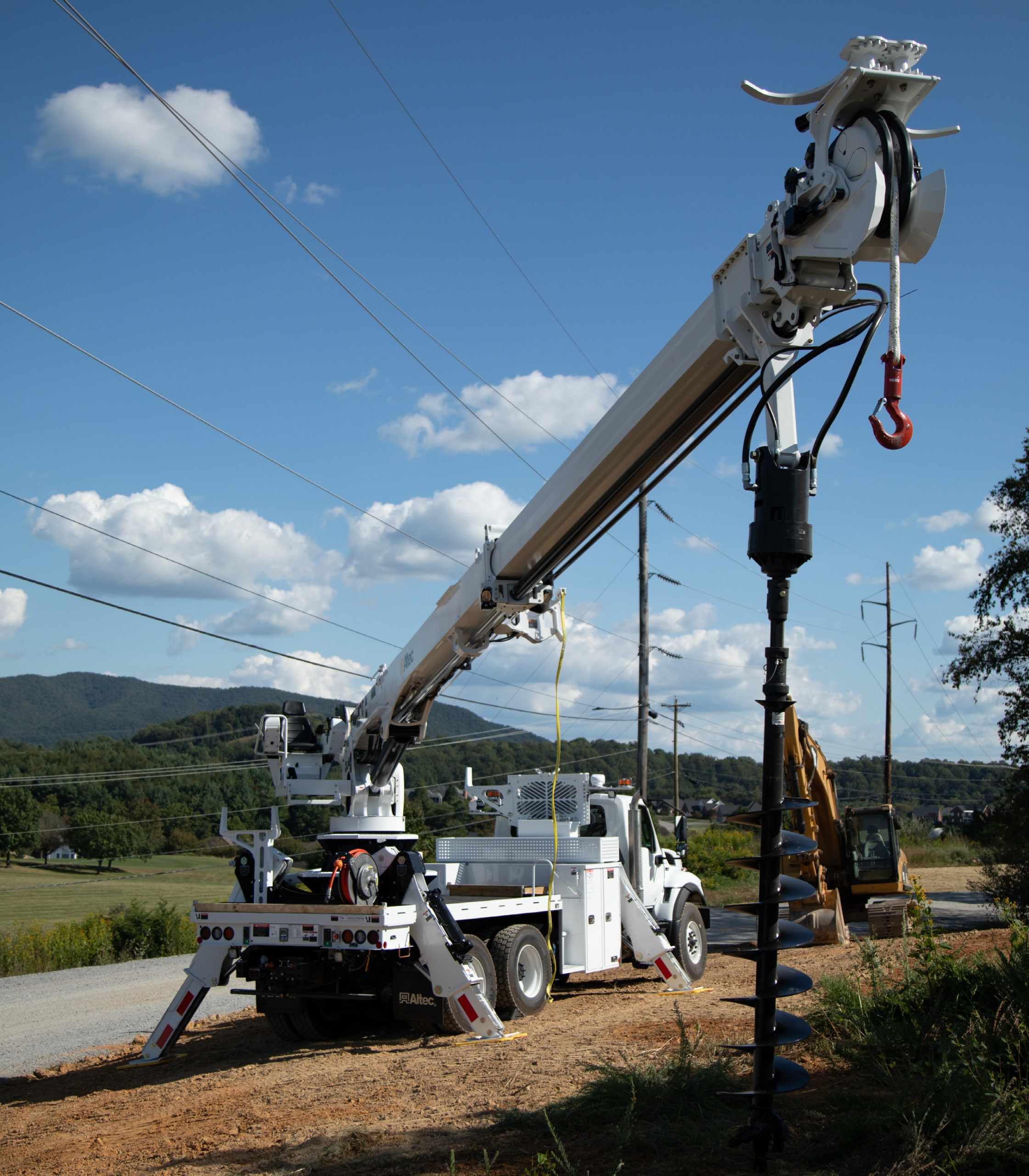 Altec crane truck drilling utility pole