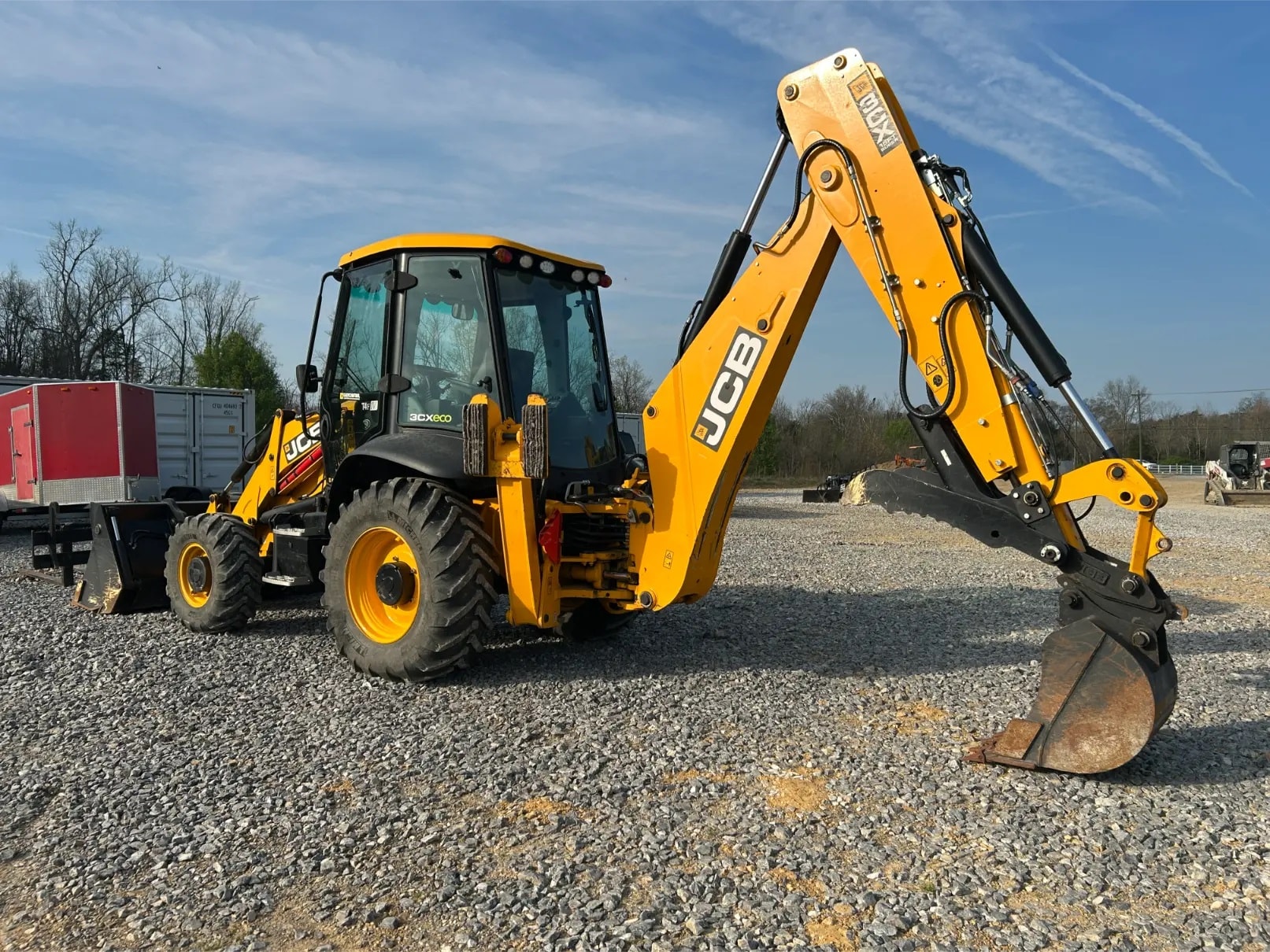 JCB backhoe on gravel lot