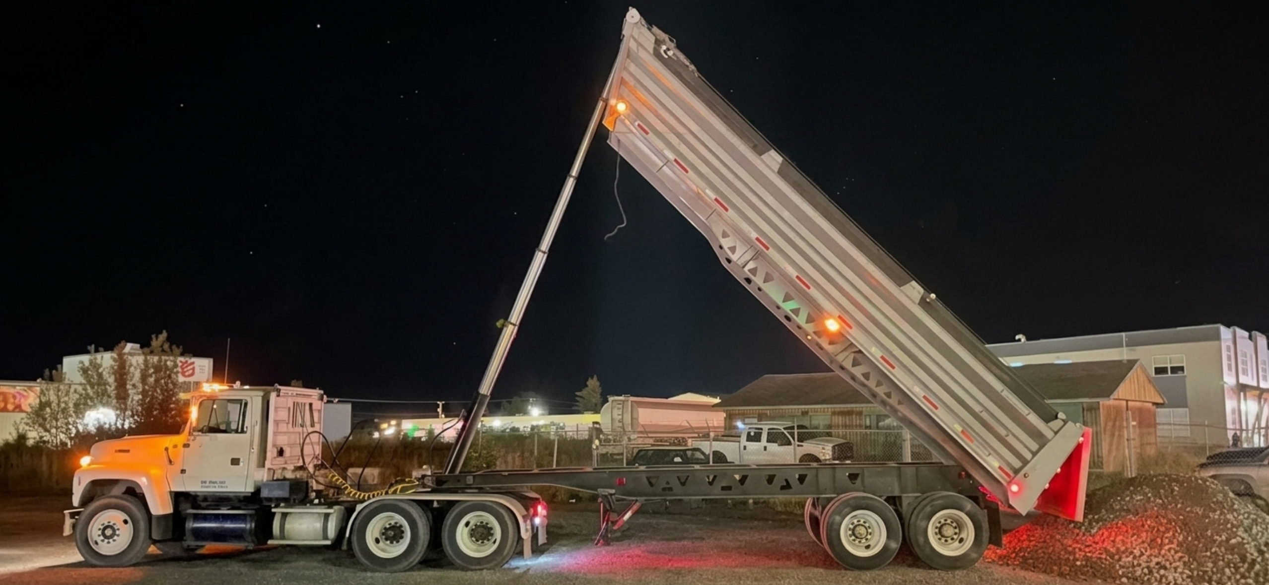 Dump truck unloading at night