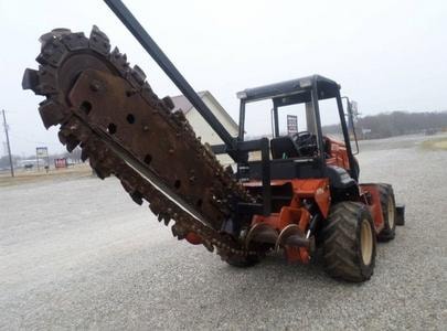 Heavy equipment operating large auger drill